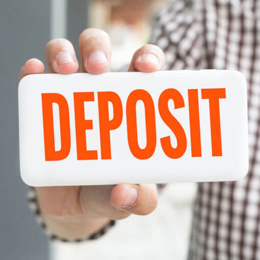 Person holding a deposit sign