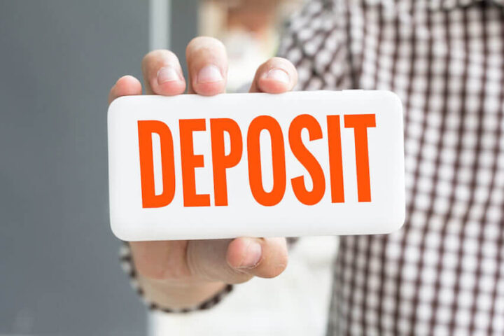 Person holding a deposit sign